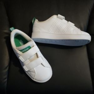 White Adidas with green stripe in the back